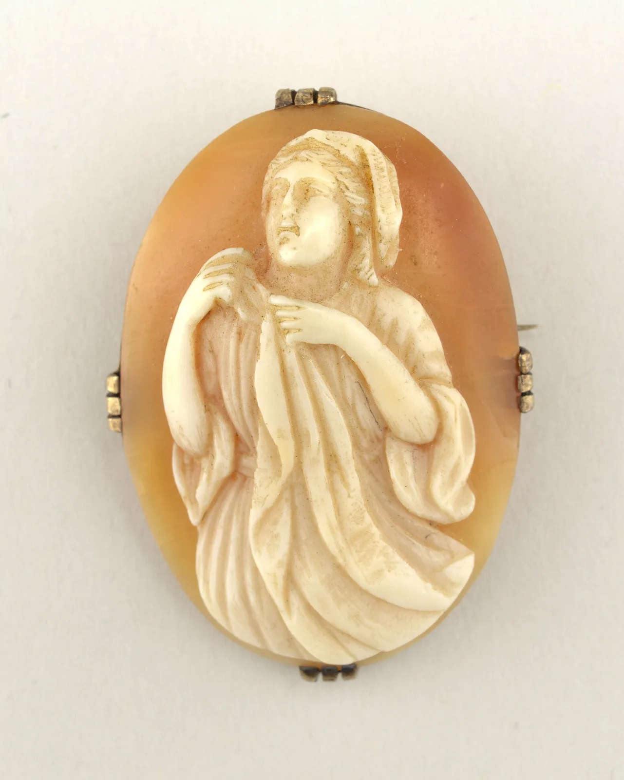 Cameo carved around 1900 showing a draped female figure in high relief, the undercut edges casting shadow against the background layer