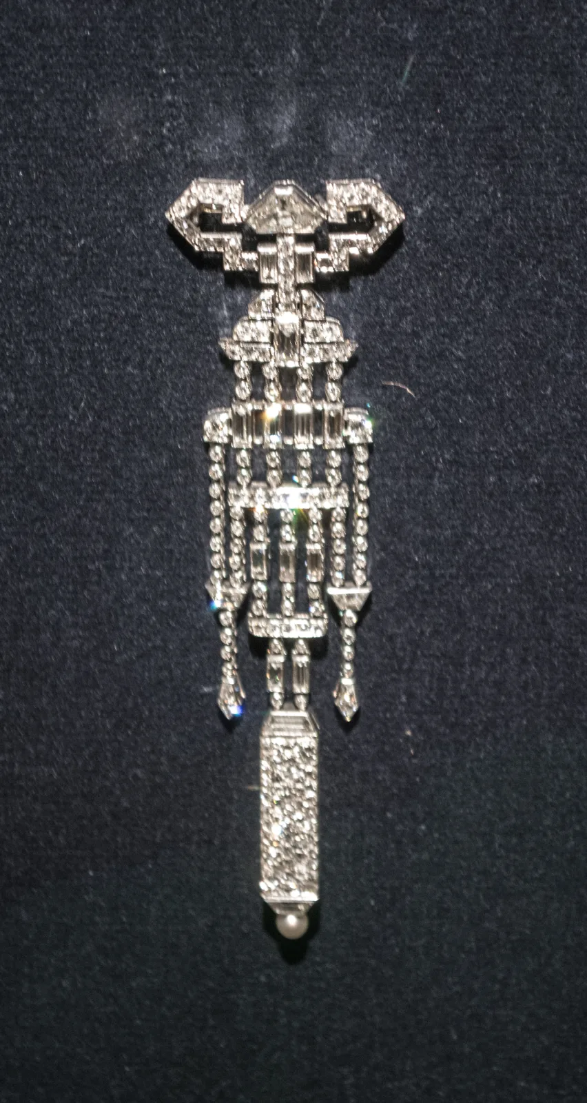 Pendant watch by Van Cleef and Arpels, the case and suspension set throughout with small diamonds in a stepped geometric frame