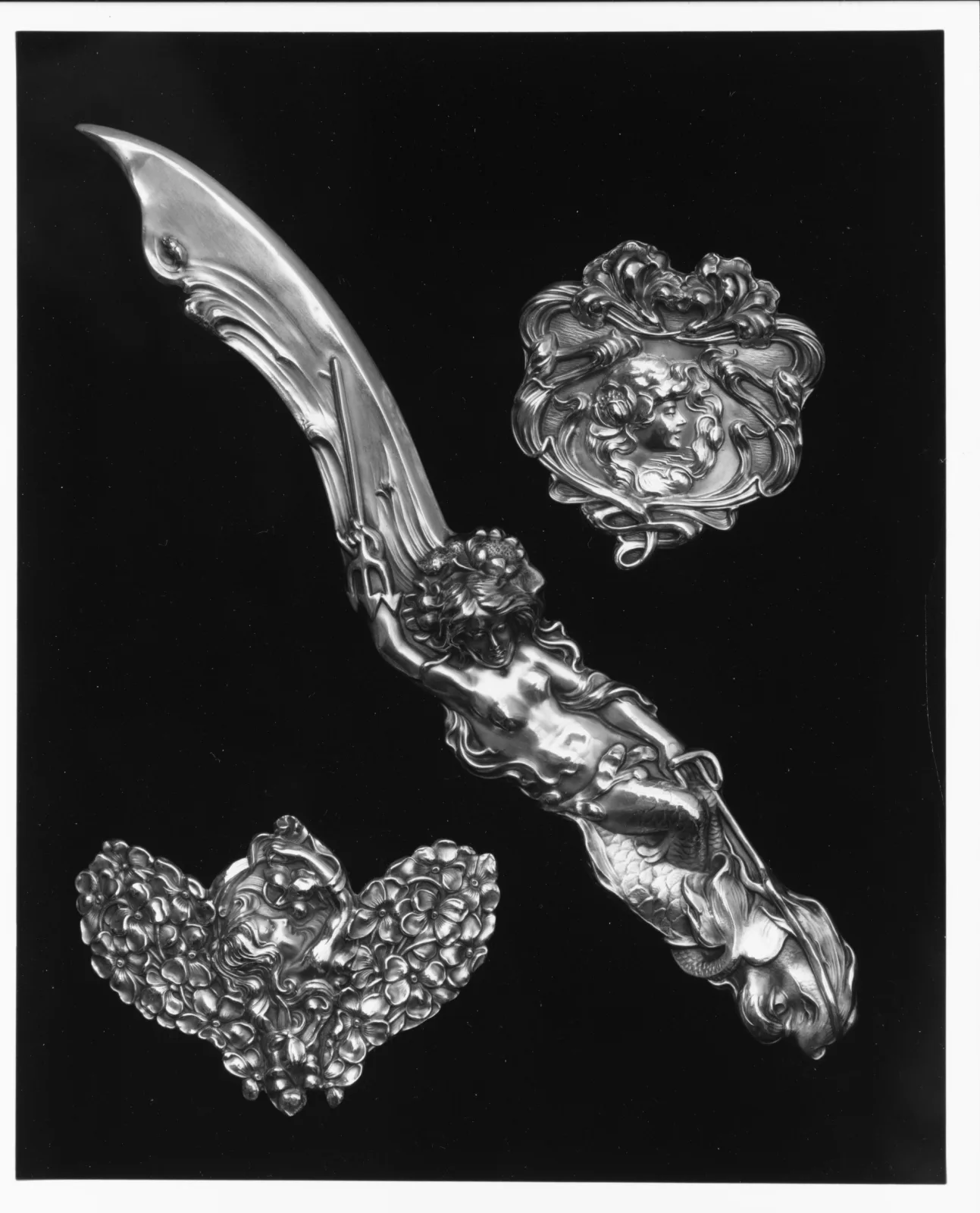 Unger Brothers sterling silver brooch featuring an Art Nouveau female head with sinuous flowing hair and repoussé detail
