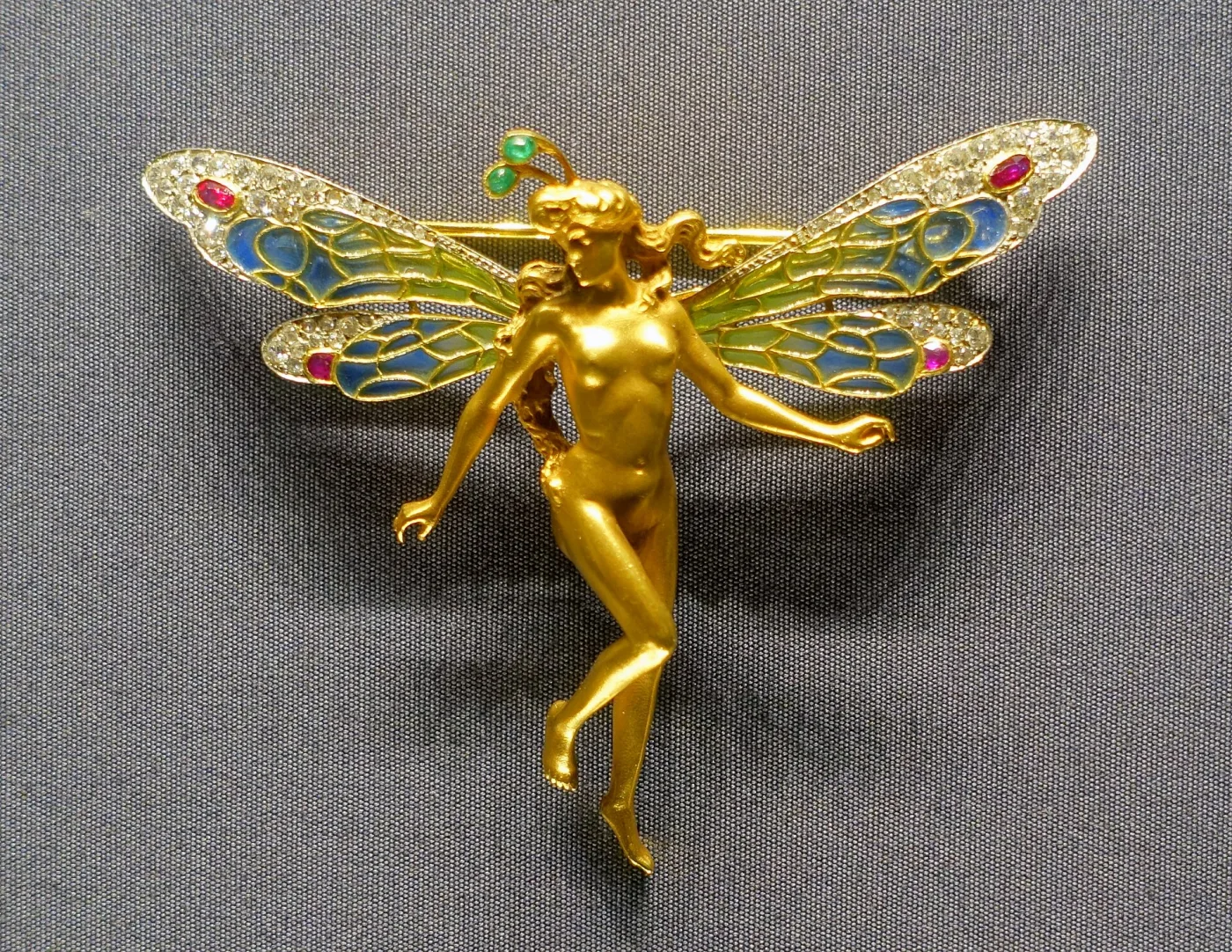Art Nouveau brooch depicting a female figure with dragonfly wings by Marie Alexandre Lucien Coudray in gold, enamel, rubies, and diamonds