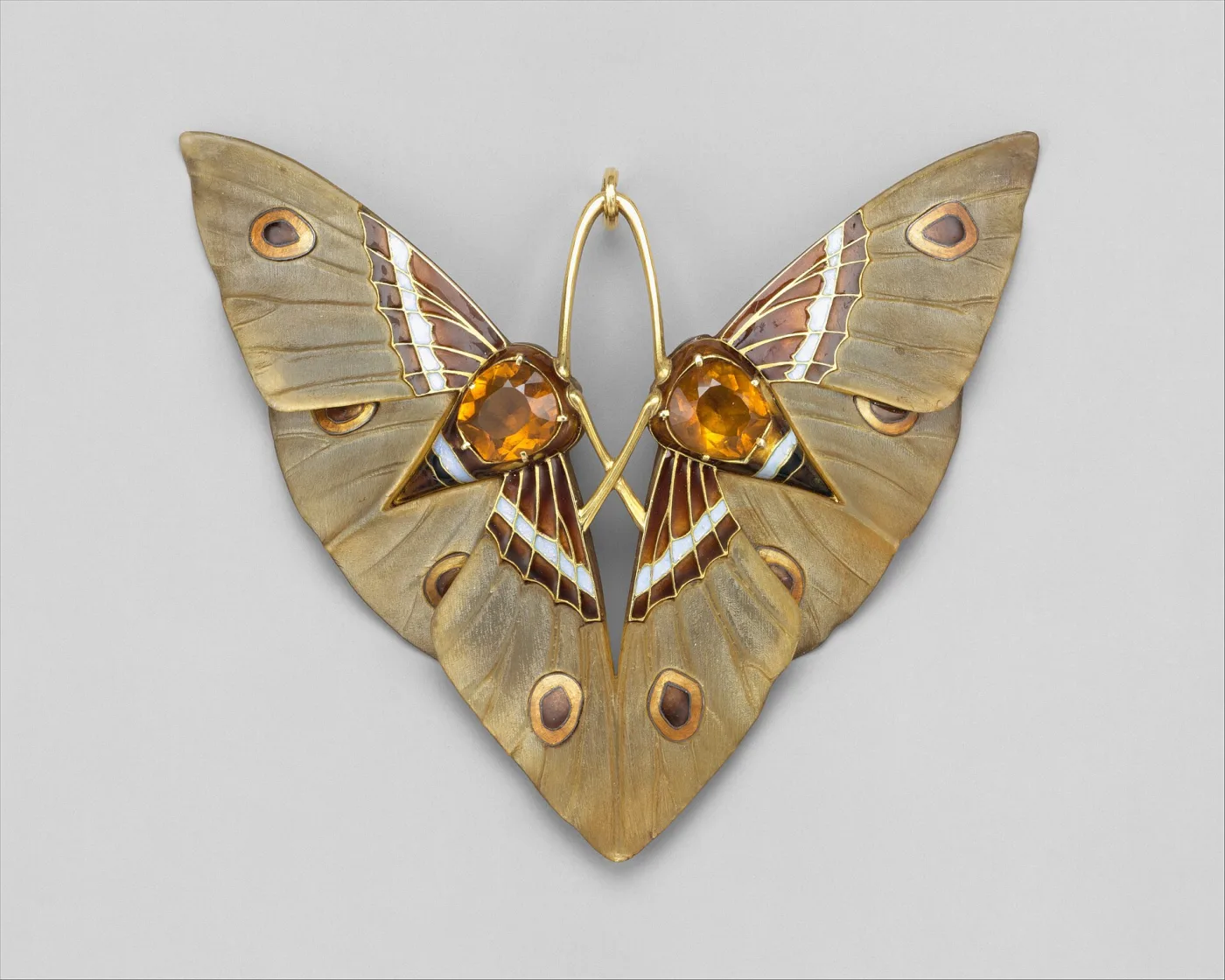 Moth pendant in carved horn and enamel by Lucien Gaillard shown alongside its original leather presentation box
