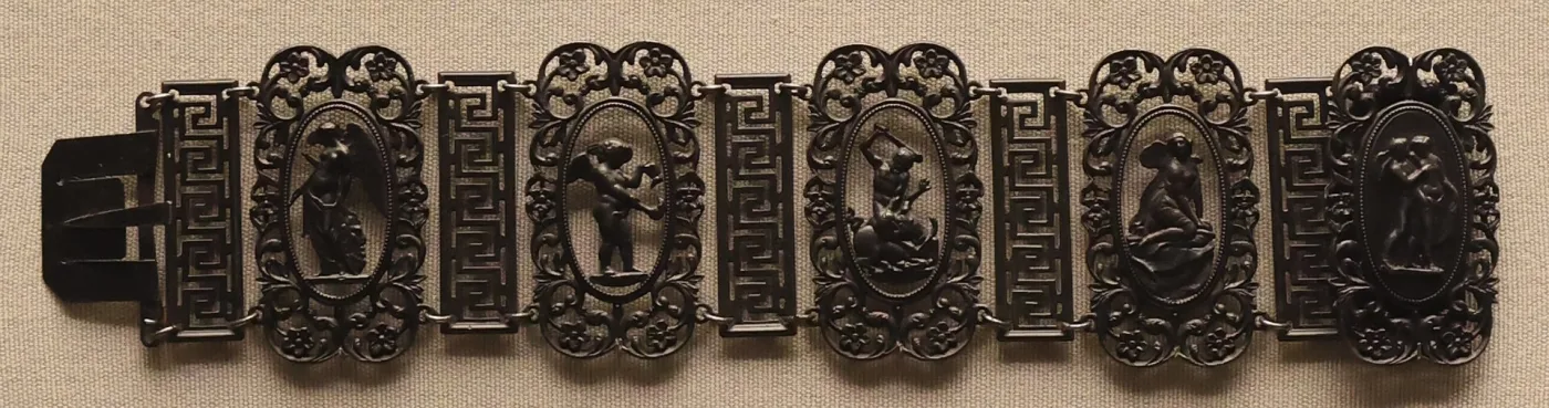 Berlin iron bracelet alternating rectangular Greek-key fret plaques with pierced floral cartouches, each framing an oval medallion of a classical figure, with a flat box clasp at one end