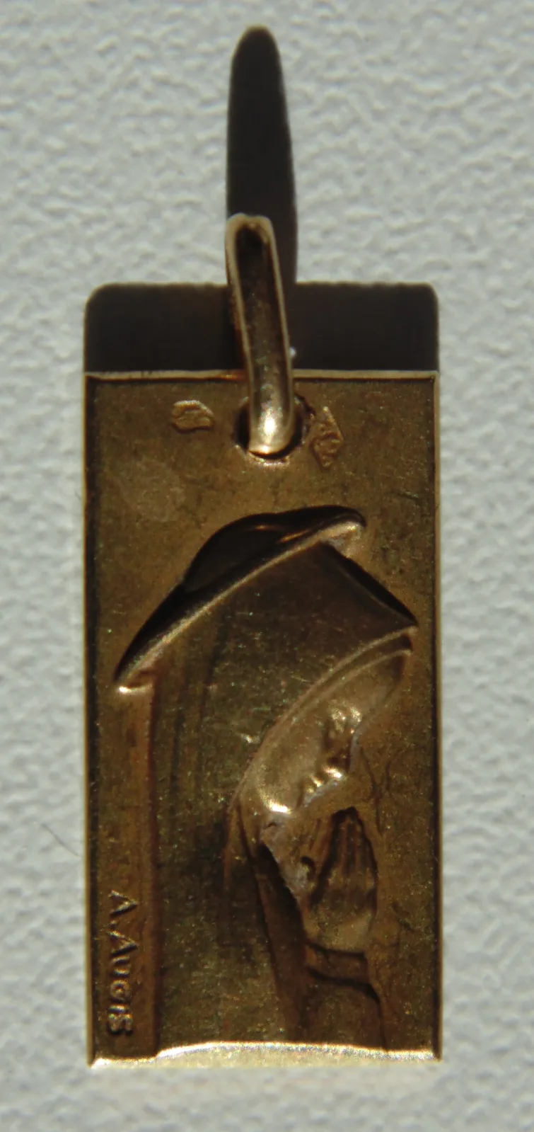 French gold baptism medal on its suspension ring, carrying two small struck punches beside the engraved figure