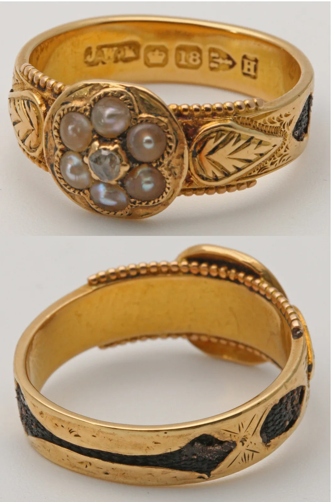 Victorian 18 carat gold mourning ring with a glazed oval compartment set into the band, holding a lock of plaited hair